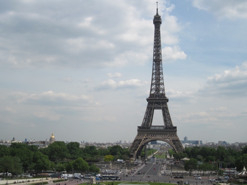 View of the Eiffel Tower from the Palais de Chaillot at Trocadero, with the golden dome of Les Invalides in the background.