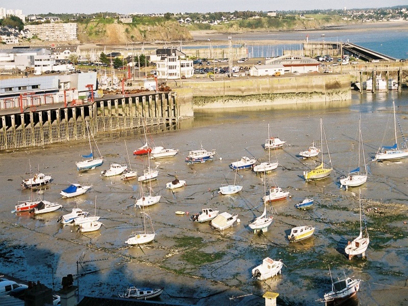 During ebb tide, the English Channel waters recede, leaving boats in the Granville port stranded.