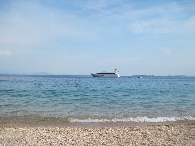 Barbati Beach, located north of Corfu Town, is a pebble beach with clear waters sitting at the base of Mount Pantokrator.