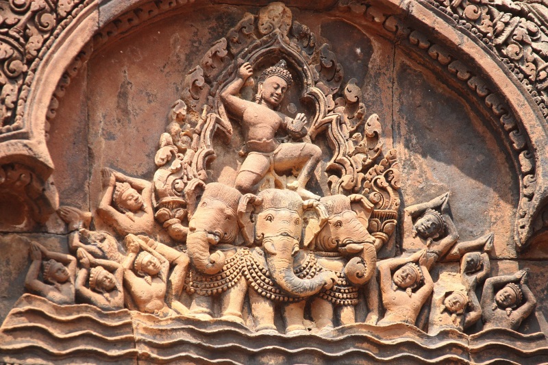 A bas-relief of Banteay Srei Temple, near Angkor Wat and Siem Reap, features an elaborate carving in red sandstone.