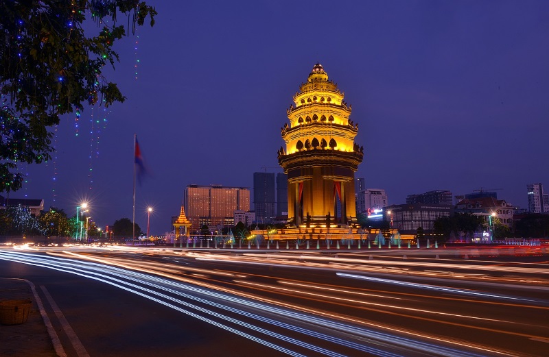 Independence Monument in Phnom Penh mimics the lotus flower bud and features multi-colored illumination during the night.