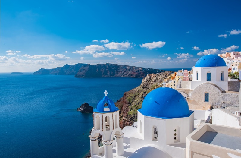 White, blue-domed churches and houses are the recognizable landmarks of the Cyclades Islands in the Aegean Sea, Greece.