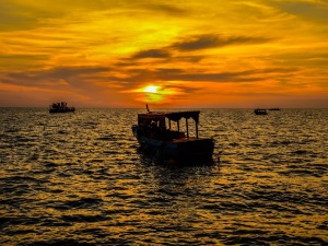 Tonle Sap Lake near Siem Reap is a hub of activities during the golden sunset as fishing and sightseeing boats get around.