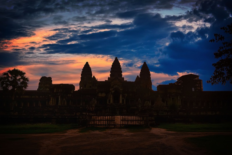 The dark silhouette of the Angkor Wat Temple during sunrise or sunset is one of the most photogenic sights near Siem Reap.