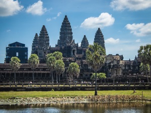 Angkor Wat is a large complex encircled by a moat featuring a few enclosures and five towers symbolizing sacred Mount Meru.